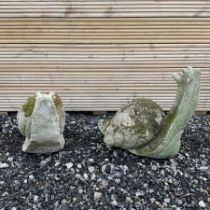 Two cast stone snail ornaments