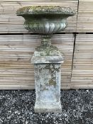 Cast stone urn on plinth