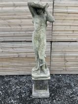 Cast stone garden figure of a woman with arms raised