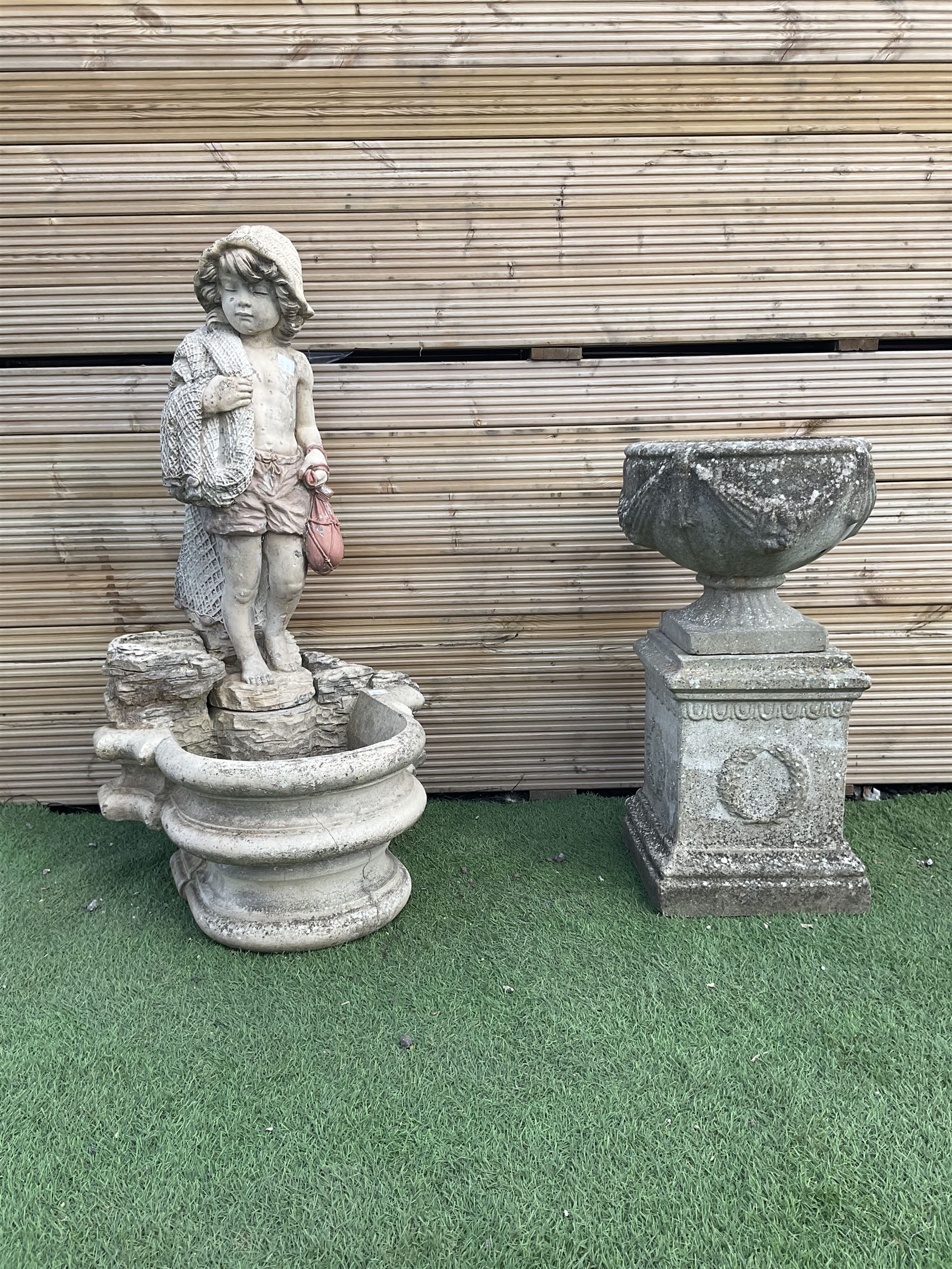 Three section cast stone garden figure of a boy carrying fishing net and a satchel with a water feat