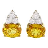 Pair of 18ct white and yellow gold round brilliant cut diamond and oval cut yellow sapphire earrings