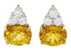 Pair of 18ct white and yellow gold round brilliant cut diamond and oval cut yellow sapphire earrings