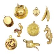Four 18ct gold gold pendant / charms including cockrill