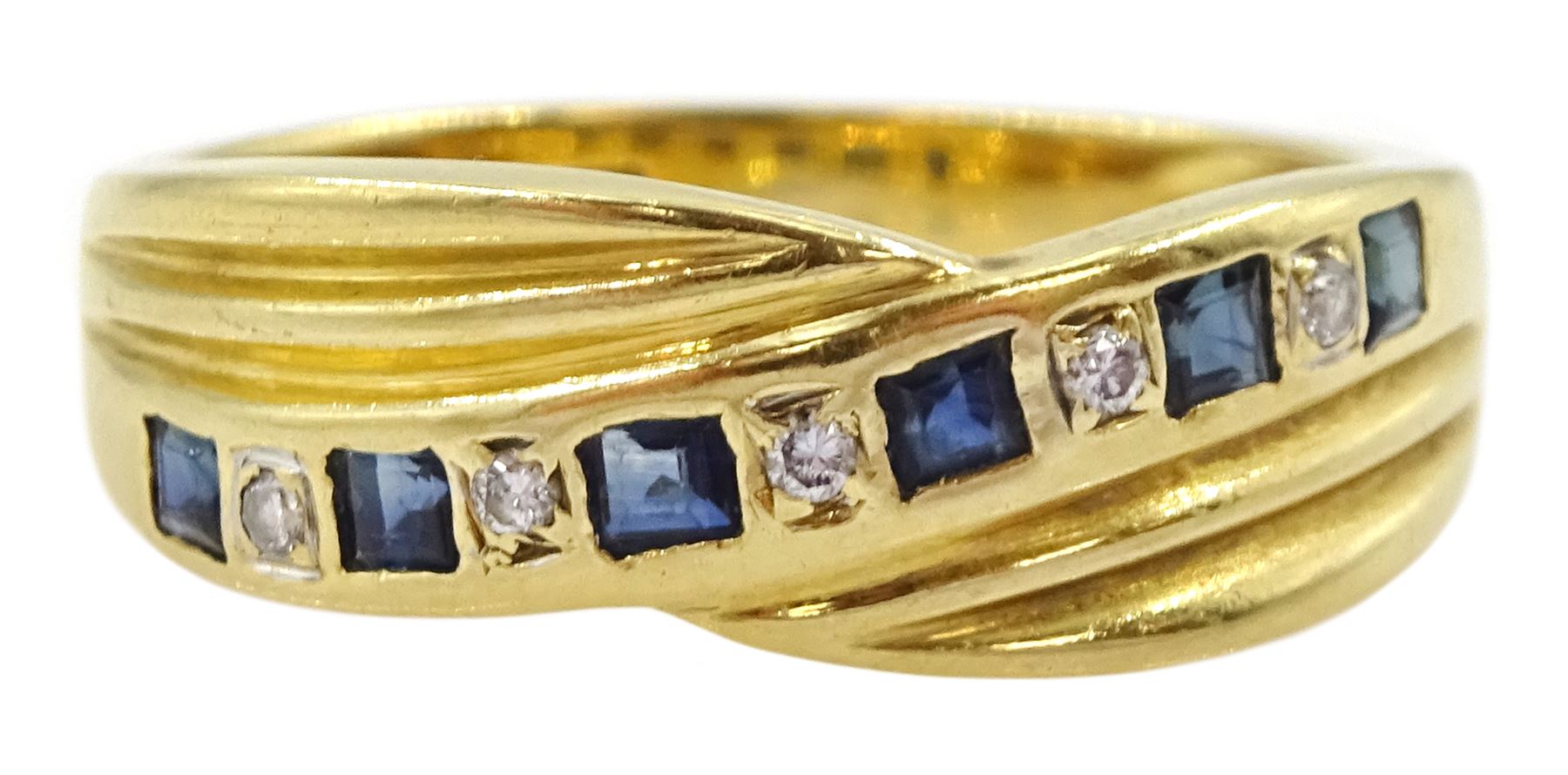 18ct gold channel set calibre cut sapphire and round cut diamond crossover ring