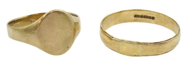 Gold wedding band and a gold signet ring