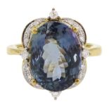 18ct gold oval cut fancy colour tanzanite and round brilliant cut diamond cluster ring