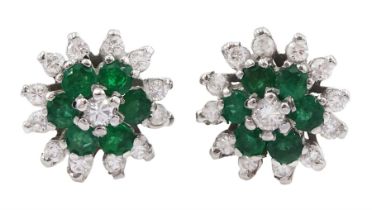 Pair of 18ct white gold emerald and round brilliant cut diamond flower head cluster stud earrings