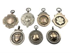 Seven early 20th century silver gold faced cartouche fobs