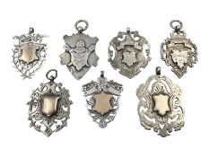 Seven Edwardian and later silver cartouche fobs