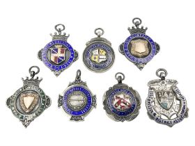 Seven early 20th century and later silver and enamel cartouche fobs