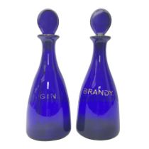 Pair of early 19th century blue glass decanters with teardrop stoppers