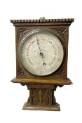Edwardian - oak cased Arts and Crafts aneroid barometer with an 8” register