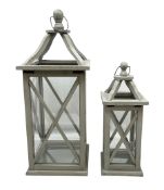 Two wooden lanterns with four glass sides