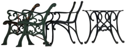 Two pairs of cast and painted metal bench ends and a pair of painted cast metal table supports
