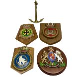 Navy crests upon wooden shields and a brass model anchor