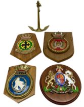 Navy crests upon wooden shields and a brass model anchor