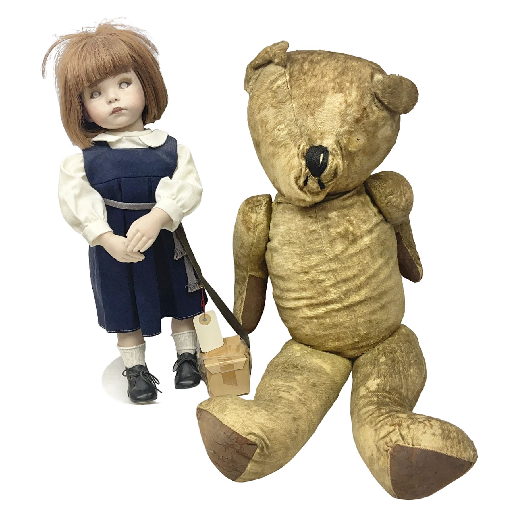 Mid-20th century woodwool filled teddy bear; and porcelain doll dressed as a WW2 evacuee