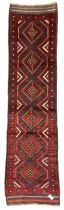 Meshwani red and blue ground runner decorated with six lozenge medallion within overall geometric de