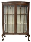 Early 20th century figured walnut bow-front display cabinet