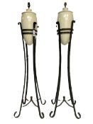 Pair of wrought metal and ceramic floor lamps