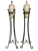 Pair of wrought metal and ceramic floor lamps