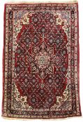 Persian design crimson ground rug