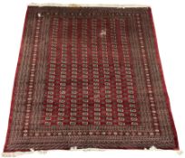 Large Persian Bokhara red ground carpet