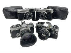 Four Olympus camera bodies