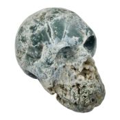 Carving of a skull in moss agate