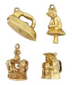 Four 9ct gold pendant / charms including imp