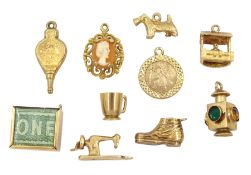 Ten 9ct gold pendant / charms including wishing well