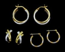 Two pairs of white and yellow gold hoop earrings and a pair of white and yellow gold crossover earri