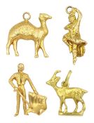 Three 18ct gold pendant / charms including matador