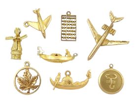 Four 9ct gold pendant / charms including aeroplane
