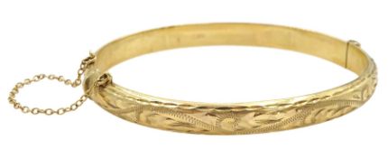9ct gold hinged bangle with engraved decoration