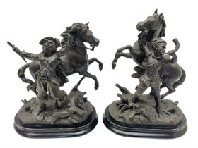 Pair of spelter figural statues of man in period dress