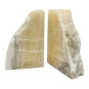 Pair of honey onyx bookends of rectangular form with polished to three sides with a raw outer edge