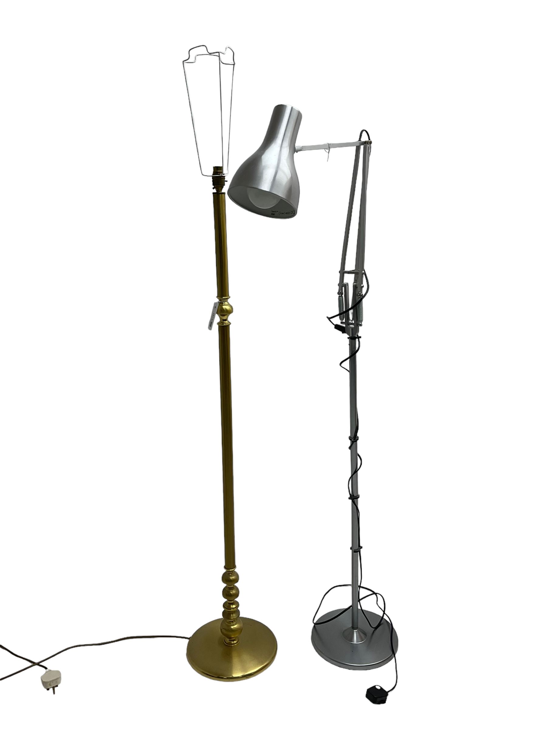Adjustable metal standard lamp; and a burnished brass standard lamp (H133cm)