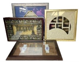 Four framed displays of Oriental decorative items