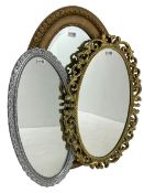 Early 20th century oval gilt framed wall mirror (85cm x 54cm); gilt framed oval mirror decorated wit