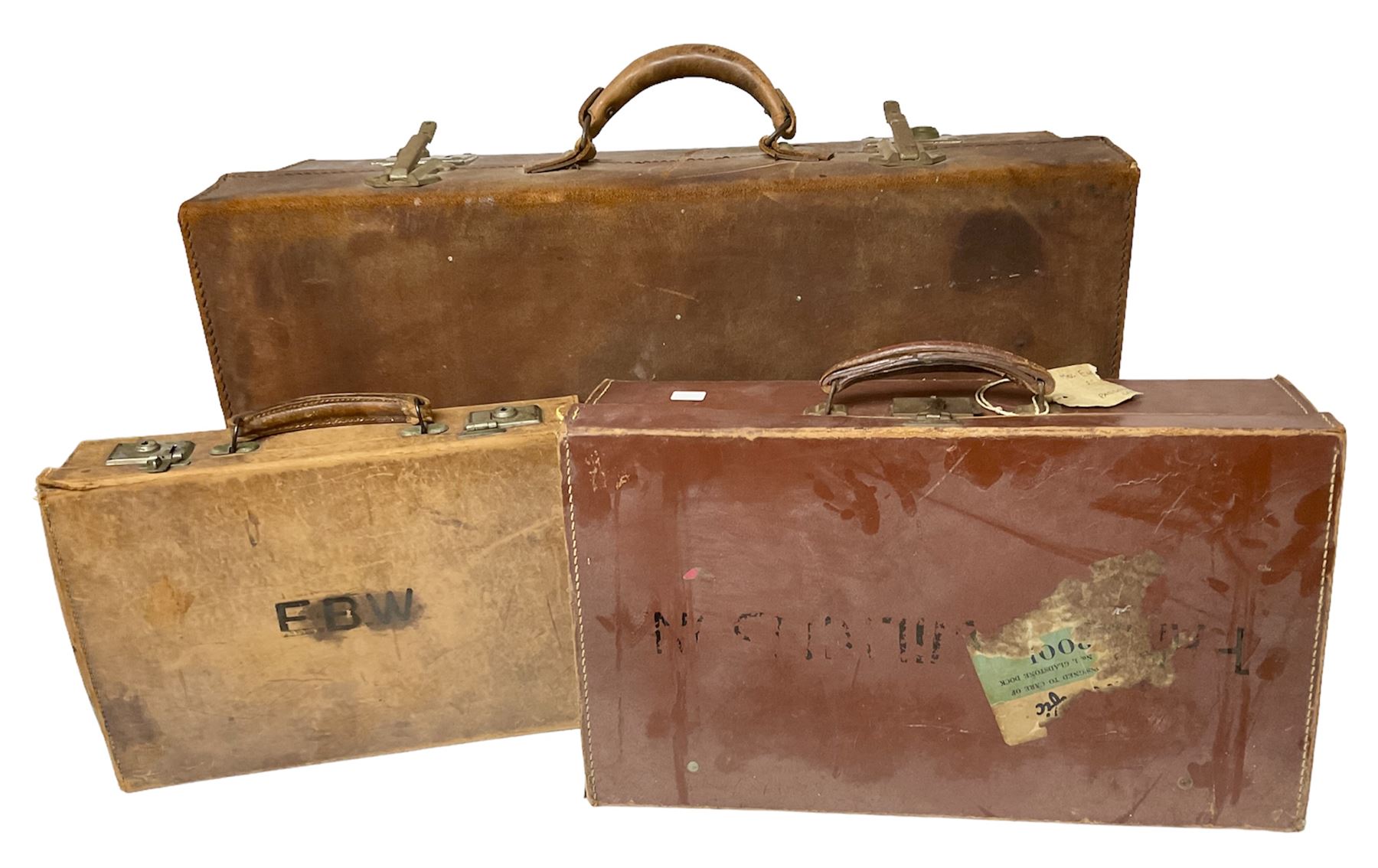 Three vintage leather suitcases