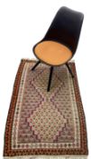 Moulded black polypropylene swivel desk chair with upholstered seat panel; an Eastern kelim rug 140c