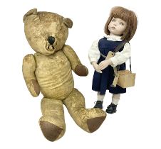 Mid-20th century woodwool filled teddy bear; and porcelain doll dressed as a WW2 evacuee