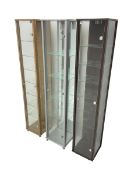 Three narrow glazed display cabinets