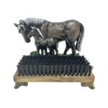 Cast iron horse and foal boot brush on wooden base