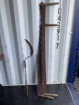 Two vintage crosscut saws and sickle