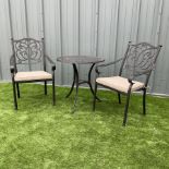 Cast metal garden table and two chairs