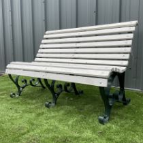 Wrought iron and wood slated bench painted in dar green and white
