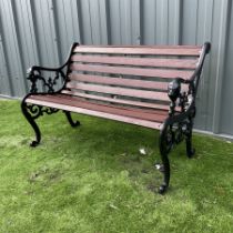 Black painted cast iron and wood slated garden bench decorated with lion heads
