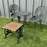 Cast aluminium garden table and two chairs with cast iron side table painted in dark green